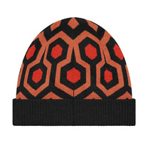 A knitted winter beanie featuring the orange, black, and tan Overlook Hotel carpet pattern inspired by The Shining.