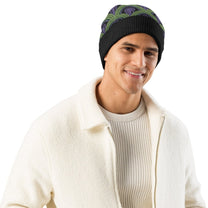 Man wearing a  green, purple and black Room 237 Overlook Hotel patterned knitted beanie from The Shining