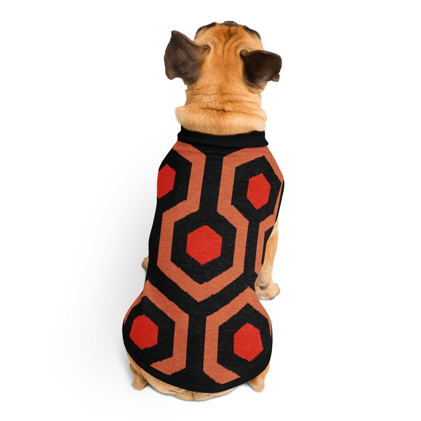 Dog wearing a Overlook Hotel carpet geometric patterned coat on a white background