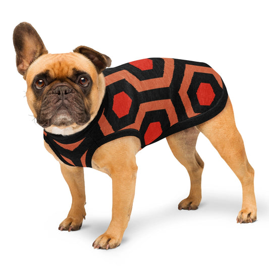 Dog wearing a Overlook Hotel carpet geometric patterned knitted jumper coat on a white background