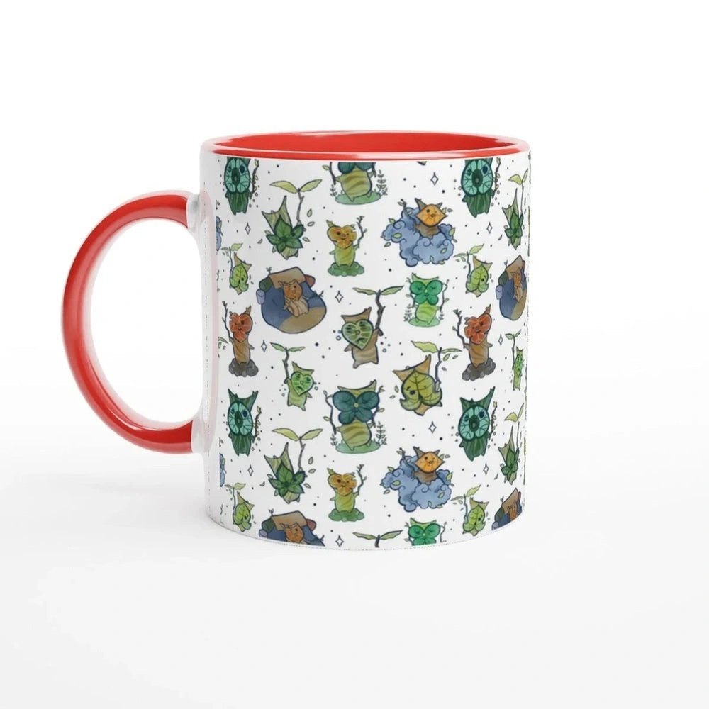 A white ceramic mug with a red handle and rim features a repeating pattern of Korok characters from The Legend of Zelda: Breath of the Wild and Tears of the Kingdom.