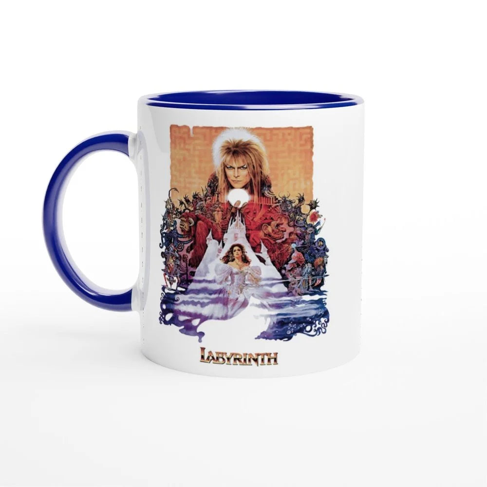 A white mug with a blue handle and rim features an illustration inspired by the 1986 fantasy movie Labyrinth, depicting Jareth the Goblin King surrounded by foliage and a smaller image of Sarah.
