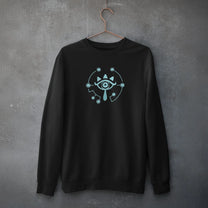 A black Zelda Sheikah Eye embroidery hoodie features a glow-in-the-dark design of an eye symbol on the front.