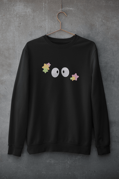 A black embroidered hoodie displays a row of small Soot Sprites inspired by Studio Ghibli animation.