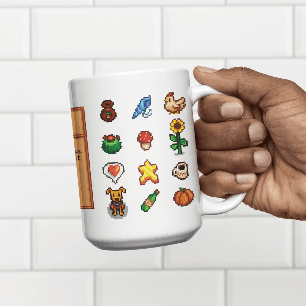 A hand holds a white mug displaying a pattern of colourful sprites representing drinks from Stardew Drinks.