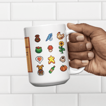 A hand holds a white mug displaying a pattern of colourful sprites representing drinks from Stardew Drinks.