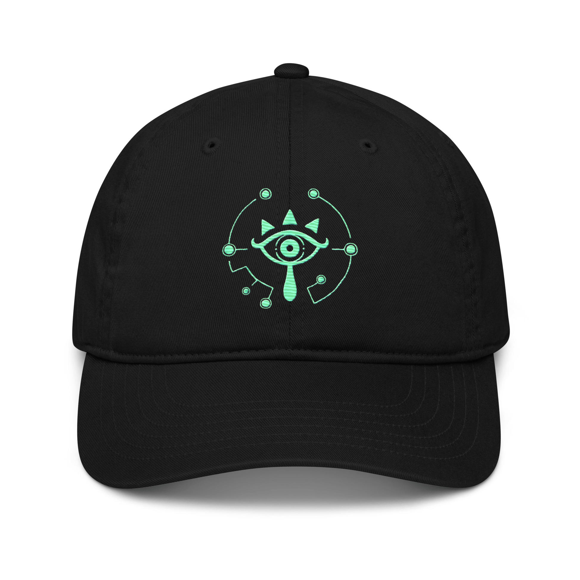 A black dad hat features a glowing green Sheikah eye emblem embroidered on the front, referencing the Tears of the Kingdom video game.