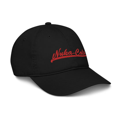 A black dad hat features red embroidered "Nuka-Cola" lettering on the front panel, referencing the Fallout video game brand.