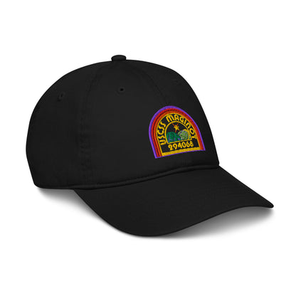 A black baseball cap features an embroidered logo depicting the USCSS Maginot from the Alien franchise in a rainbow style design.