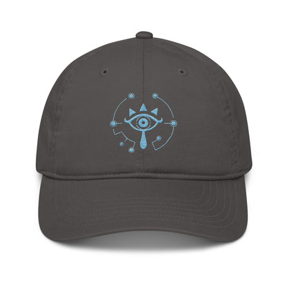 A gray Zelda Sheikah embroidered dad hat features a blue eye symbol design inspired by Tears of the Kingdom.