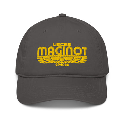A gray baseball cap features an embroidered logo displaying "USCSS MAGINOT" and stylized wings referencing Alien Earth.