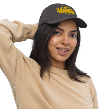 A person wearing a dark gray Alien Earth embroidered baseball cap featuring the yellow USCSS Maginot Wings logo on the front.