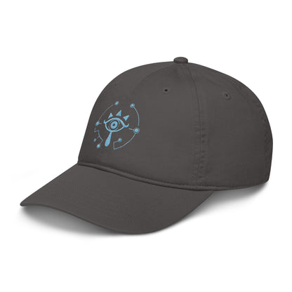A gray dad hat features an embroidered blue Sheikah eye symbol from The Legend of Zelda: Tears of the Kingdom.