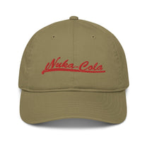 A tan Nuka Cola embroidered dad hat features red script lettering across the front panel.