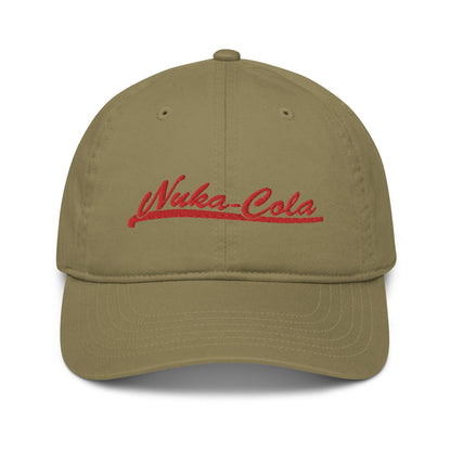 A tan Nuka Cola embroidered dad hat features red script lettering across the front panel.