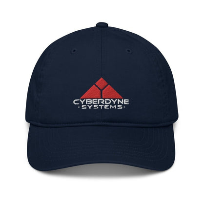 A navy blue baseball cap features an embroidered Cyberdyne Systems logo with a red triangle and white lettering on the front panel.
