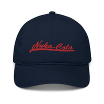 A navy blue dad hat features red embroidered "Nuka-Cola" branding referencing the Fallout video game series.