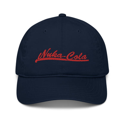A navy blue dad hat features red embroidered "Nuka-Cola" branding referencing the Fallout video game series.