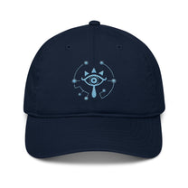 A navy blue Zelda Sheikah embroidered cap features a glowing design of an eye symbol from Tears of the Kingdom.