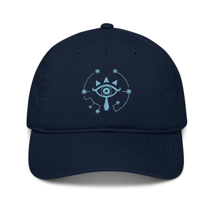 A navy blue Zelda Sheikah embroidered cap features a glowing design of an eye symbol from Tears of the Kingdom.