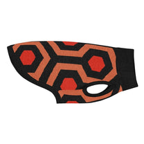 A knit pet sweater featuring a black, orange, and red geometric pattern inspired by the Overlook Hotel carpet.