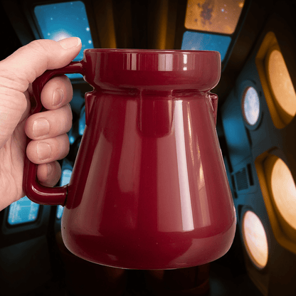 A hand holds a red Raktajino Replica Mug resembling a Big Red Synth Ale container from Quark's Bar on DS9.