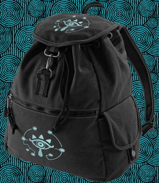 This black Zelda embroidered Sheikah backpack features glow-in-the-dark embroidery of a stylized eye symbol on the front and top.