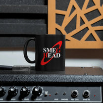 A black mug featuring the text Smeg Head in white font with a red circle behind it, inspired by Red Dwarf.
