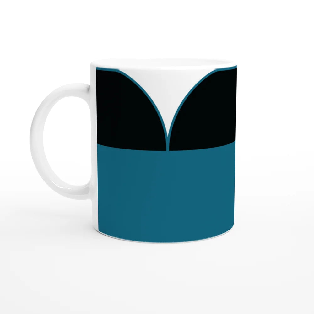 A white mug displays a design inspired by Star Trek TNG uniforms featuring blue and black panels resembling a crew member's tunic.