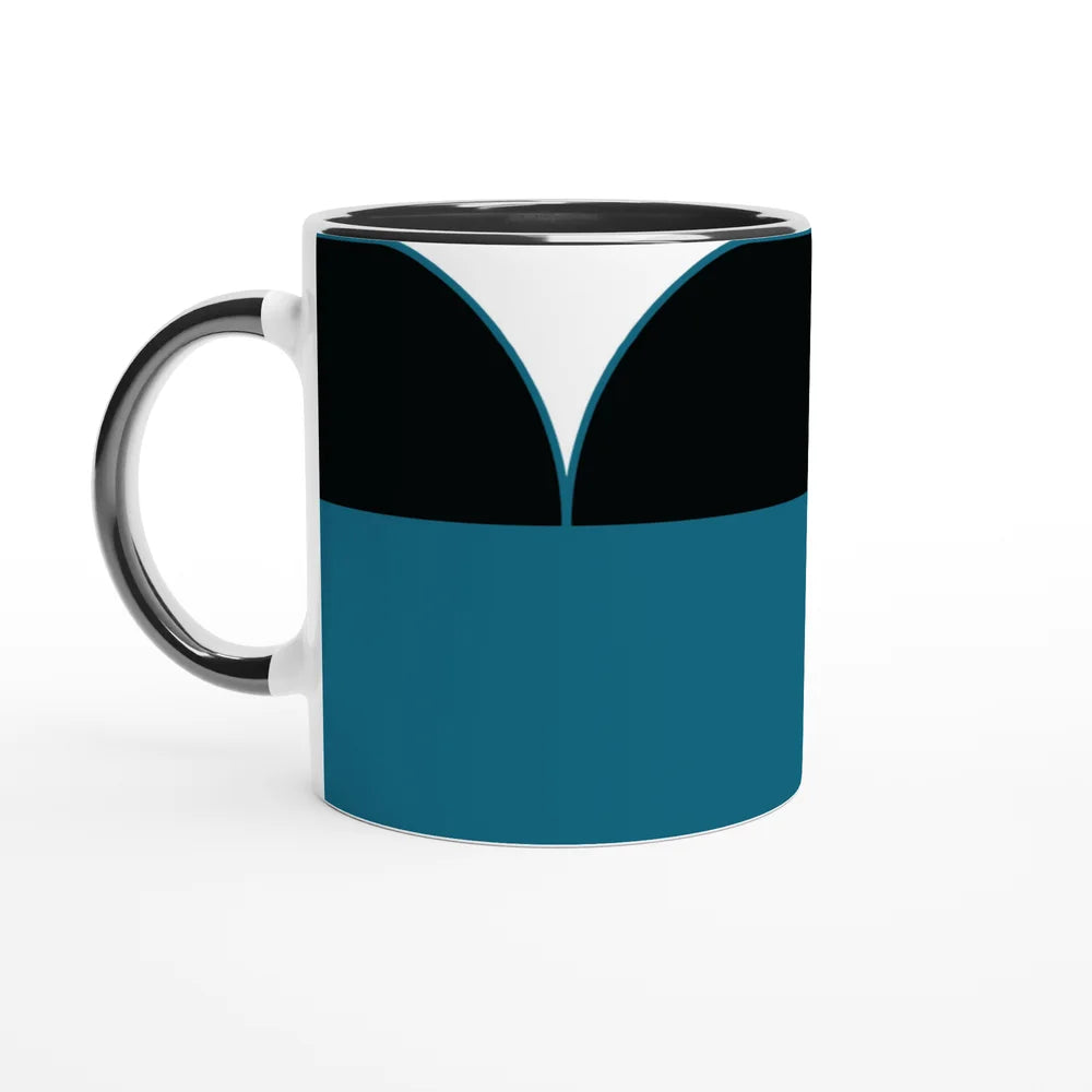 A white ceramic mug displays a design inspired by Star Trek: The Next Generation uniforms, featuring blue, black, and white geometric shapes.