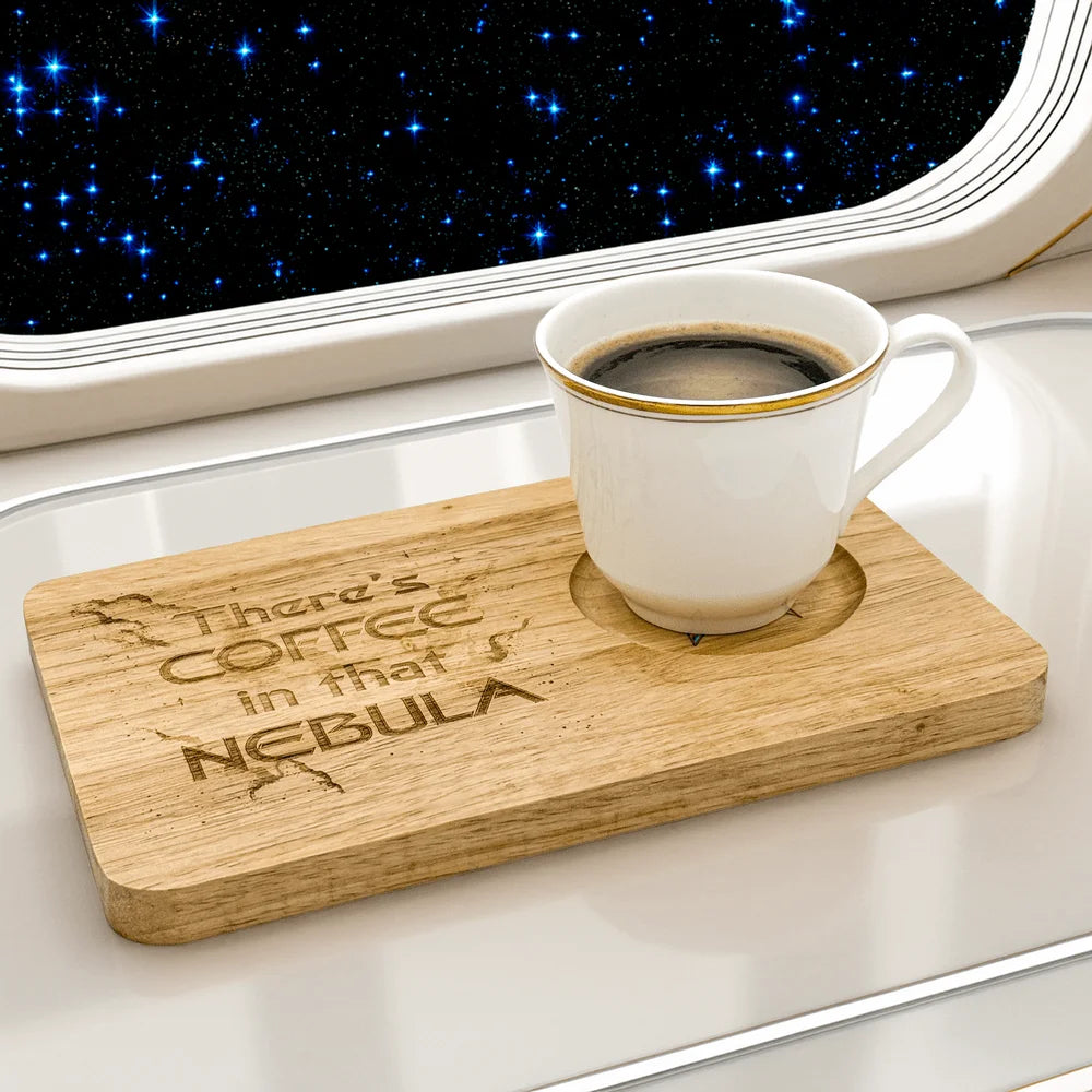 A wooden Voyager Breakfast Board displays the phrase "There's Coffee in that Nebula" and holds a mug of coffee while set against a backdrop of stars.