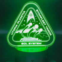 The illuminated acrylic lamp features an engraved design of the Utopia Planitia Starfleet Yards logo with spaceships and the Sol System text.
