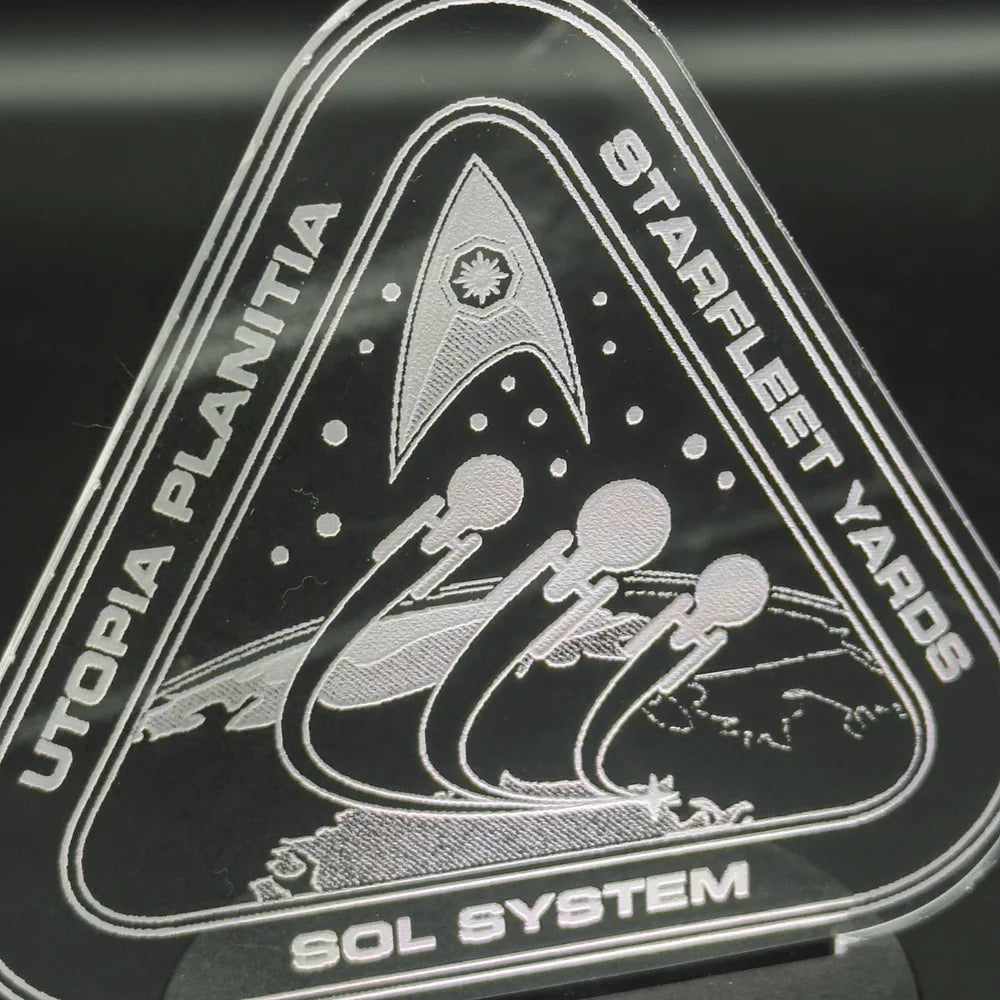 The engraved acrylic lamp depicts a Starfleet Yards insignia featuring stylized spacecraft orbiting Utopia Planitia, along with the words "Starfleet Yards" and "Sol System.
