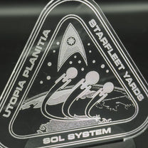 The engraved acrylic lamp depicts a Starfleet Yards insignia featuring stylized spacecraft orbiting Utopia Planitia, along with the words "Starfleet Yards" and "Sol System.