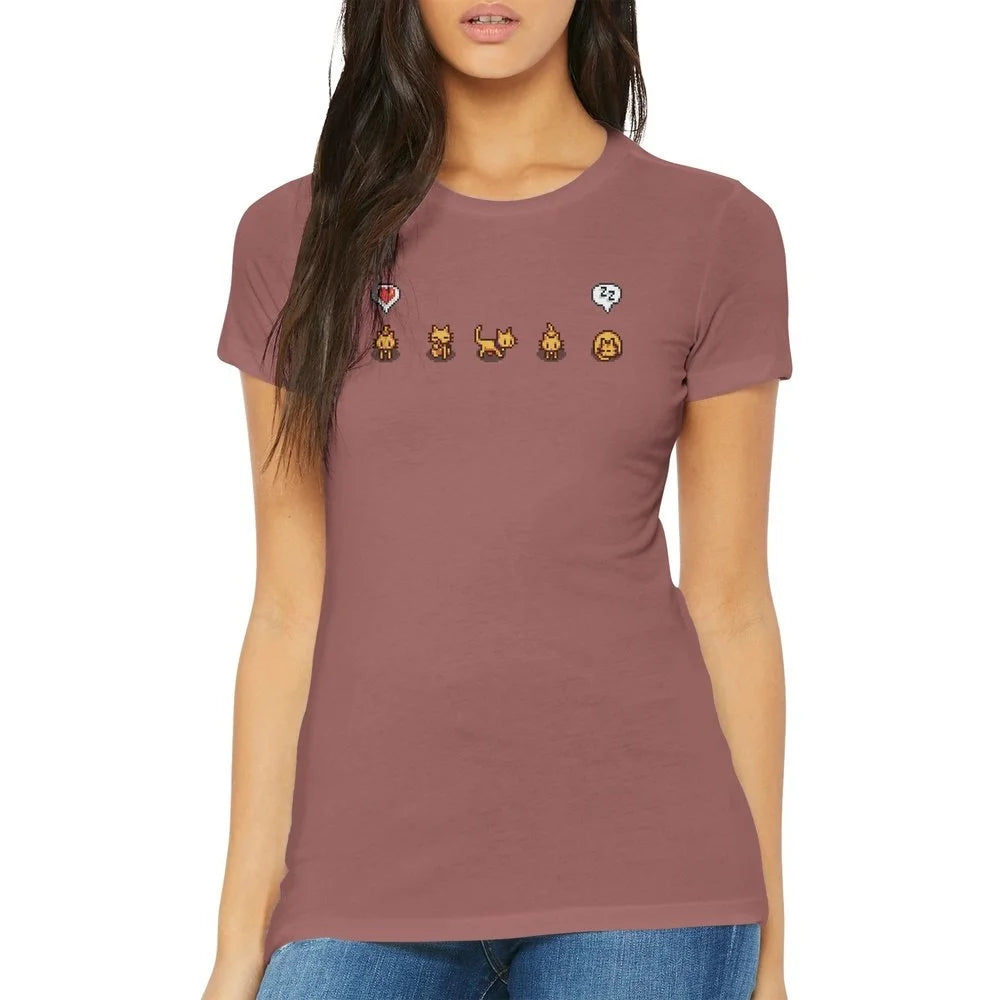 A woman wears a fitted Stardew Valley T-Shirt featuring illustrations of ginger cats and emotes across the chest.