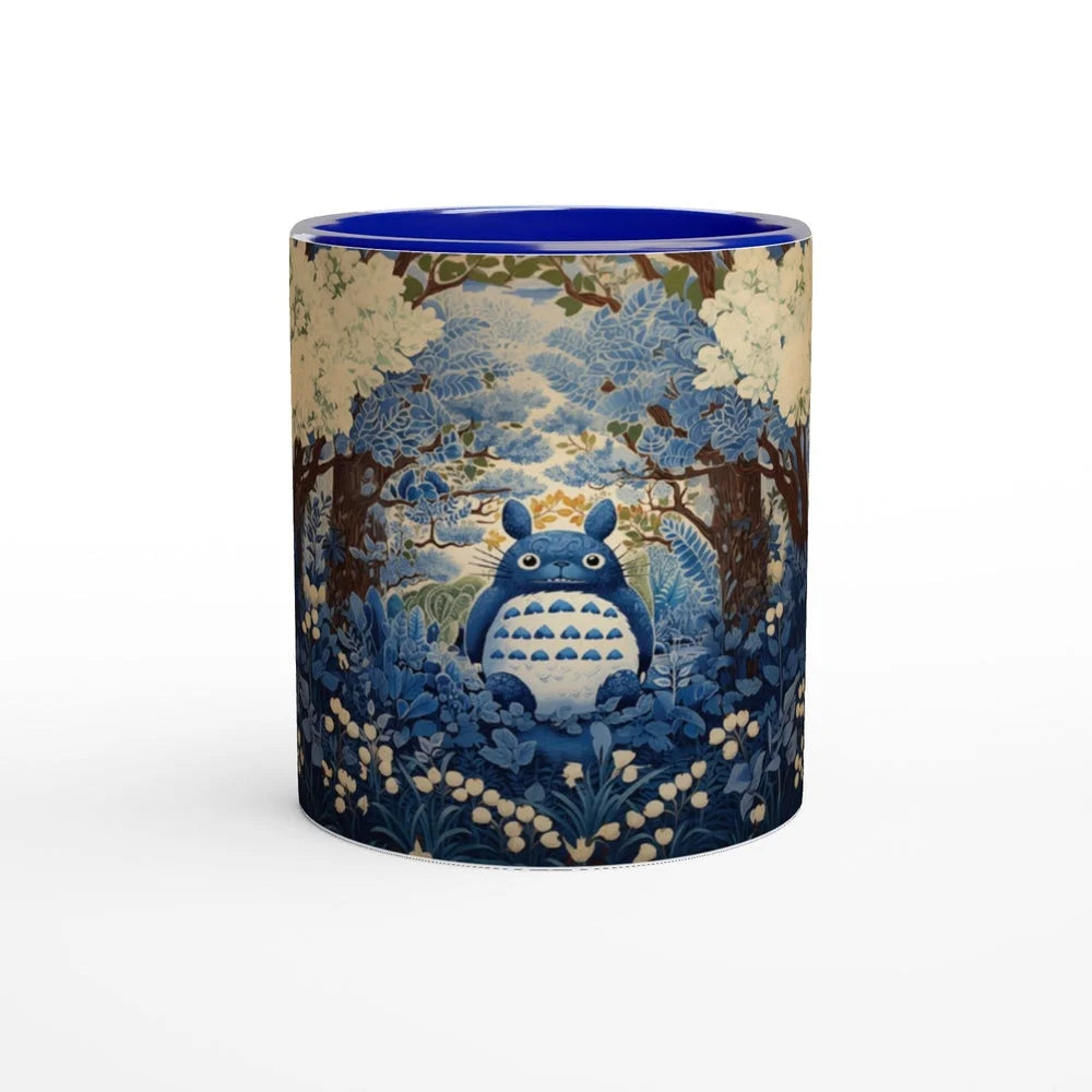 A ceramic mug depicts Totoro from Studio Ghibli sitting amongst a blue and white cherry blossom forest in a chinoiserie style.