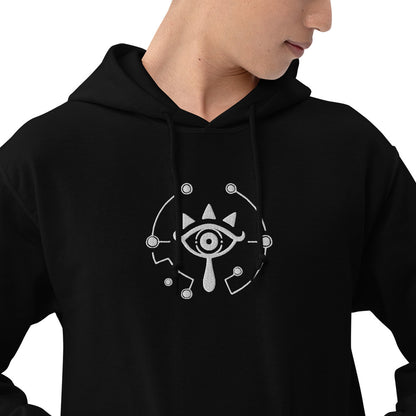 A black hoodie displays an embroidered Sheikah Eye design inspired by The Legend of Zelda: Breath of the Wild and Tears of the Kingdom.