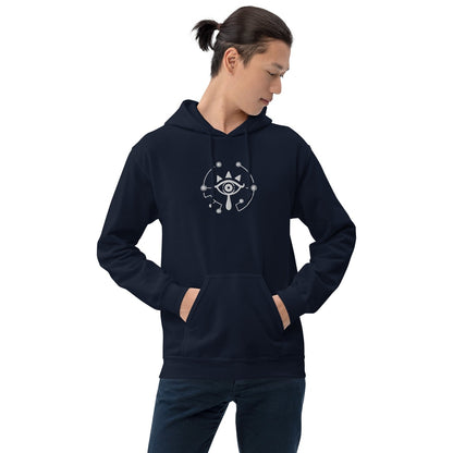 A person wearing a dark blue hoodie featuring an embroidered Sheikah Eye design inspired by The Legend of Zelda video games.