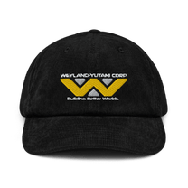 A black baseball cap features an embroidered Weyland-Yutani Corp logo with the text "Building Better Worlds" underneath.