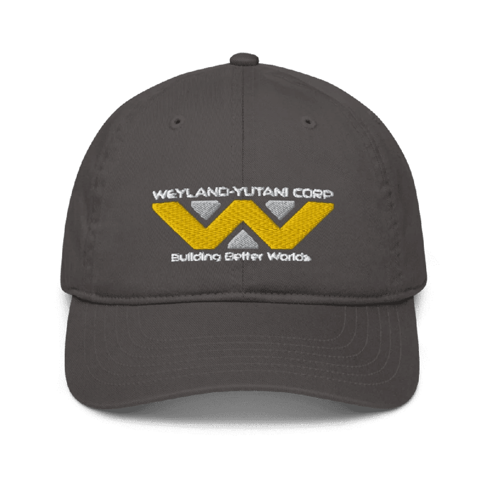A gray baseball cap features an embroidered Weyland-Yutani Corp logo with yellow and white geometric shapes and the words "Building Better Worlds.