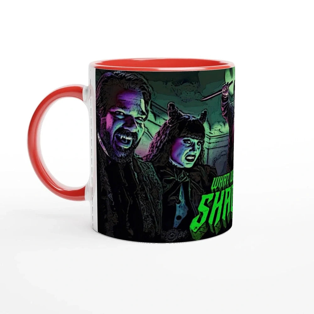 A red mug displays an illustration of Laszlo and Nadja from What We Do In The Shadows, along with a partial view of another figure and text on the side.