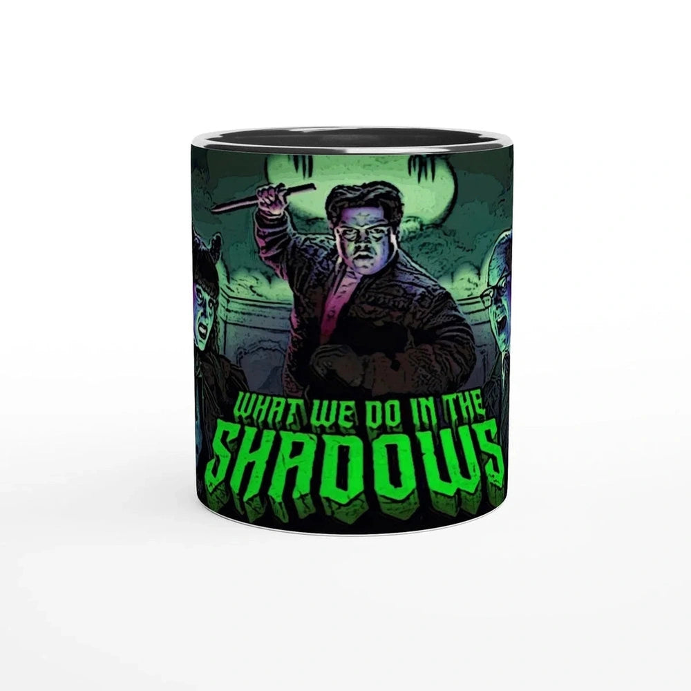 This mug features a stylized illustration of Guillermo and other characters from What We Do In The Shadows, including Laszlo, Nadja, Nandor, and Colin Robinson.